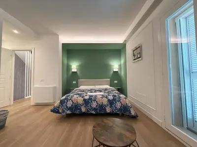 a bedroom with a bed and a table at Villa Angela in Rome