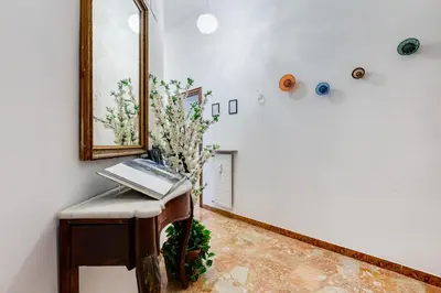 a room with a table with a laptop on it at BDC - Galatea Art Gallery 3BDR at Testaccio in Rome