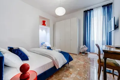 a bedroom with a bed and a table and a desk at BDC - Galatea Art Gallery 3BDR at Testaccio in Rome