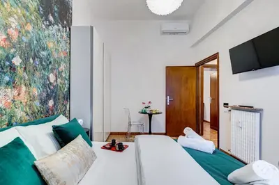 a living room with a white couch and a painting at BDC - Galatea Art Gallery 3BDR at Testaccio in Rome