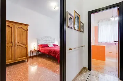 a bedroom with a bed with a red bedspread at Rossini Home in Rome