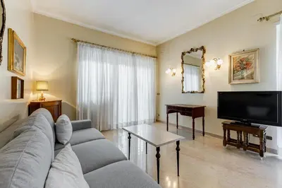 a living room with a couch and a flat screen tv at Rossini Home in Rome