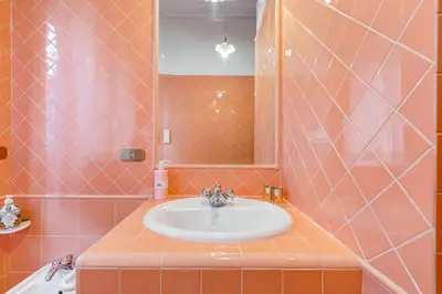a bathroom with a sink and a mirror at Rossini Home in Rome