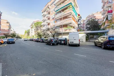 a street with cars parked on the side of the road at Rossini Home in Rome