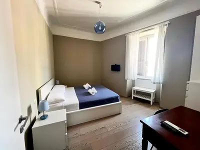 a bedroom with a bed and a desk and a desk at La Casa Di Piero in Via Ottaviano in Rome
