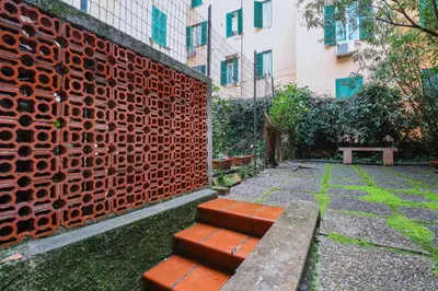 a bench sitting next to a red brick wall at Authentic Central Roman Home - Metro 7min, 5min to Rome Center, AC, Wi-Fi in Rome