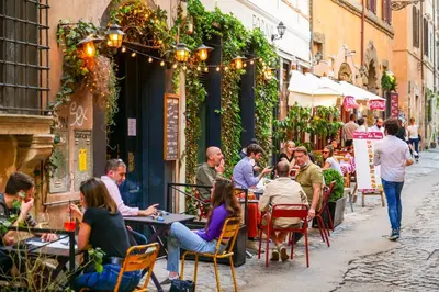 a group of people sitting at tables outside a restaurant at Authentic Central Roman Home - Metro 7min, 5min to Rome Center, AC, Wi-Fi in Rome