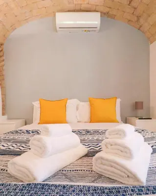 a bedroom with a bed with towels on it at Authentic Central Roman Home - Metro 7min, 5min to Rome Center, AC, Wi-Fi in Rome