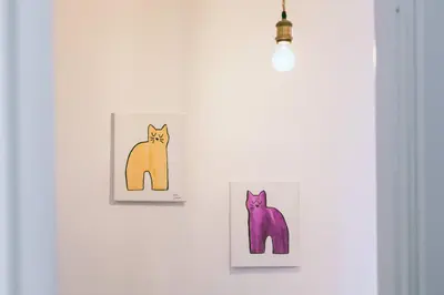 two paintings of cats hanging on a wall at Blu Colombo in Rome
