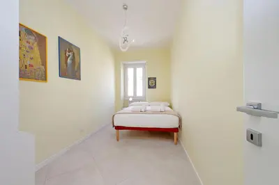 a bedroom with a white bed and a white dresser at 4BNB - Jacuzzi Trionfale Apartment in Rome