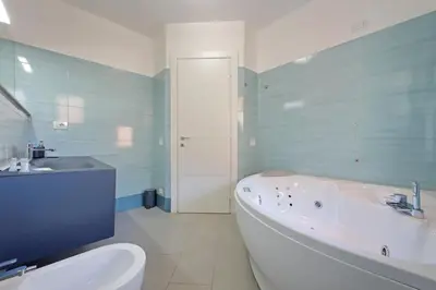 a bathroom with a tub and a toilet and a sink at 4BNB - Jacuzzi Trionfale Apartment in Rome