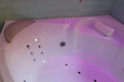 a white bath tub with a pink light on it at 4BNB - Jacuzzi Trionfale Apartment in Rome
