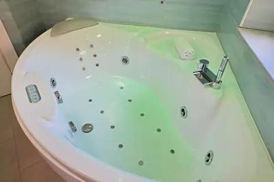 a bathroom with a bath tub with a shower at 4BNB - Jacuzzi Trionfale Apartment in Rome