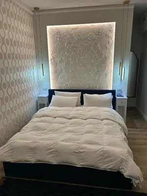 a bedroom with a large bed with white sheets and pillows at laurus's house in Rome