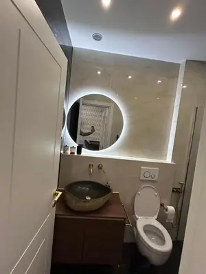a bathroom with a sink and a toilet and a mirror at laurus's house in Rome