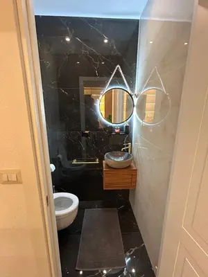 a bathroom with a sink and a toilet and a mirror at laurus's house in Rome
