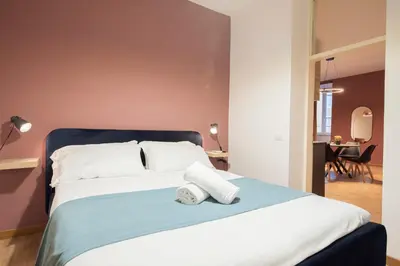 a bedroom with a bed with two towels on it at Pallaro 6 Apartment in Rome