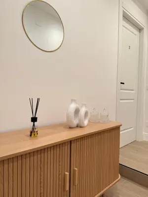 a mirror on top of a wooden dresser in a room at Vita Lux Vatican Suites in Rome
