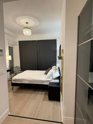 a bedroom with a bed with a black headboard at Vita Lux Vatican Suites in Rome