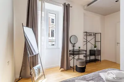 a bedroom with a mirror and a dressing table at iFlat Monti Brand New Peaceful Apartment in Rome