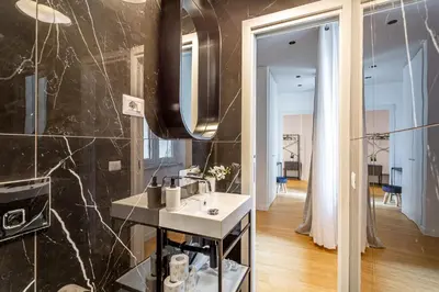 a bathroom with a sink and a mirror at iFlat Monti Brand New Peaceful Apartment in Rome