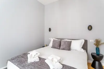 a bedroom with a white bed with towels on it at iFlat Monti Brand New Peaceful Apartment in Rome