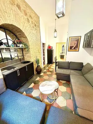 a living room with a couch and a table at Vatican Prestige Suite 