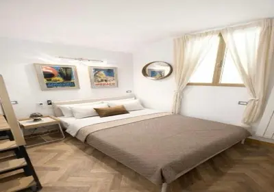 a bedroom with a large bed and a window at Vatican Prestige Suite 