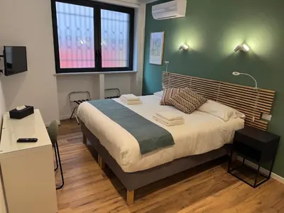 a bedroom with a large bed in a room at Luce suite trastevere in Rome
