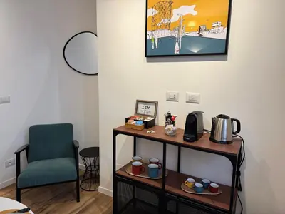 a room with a table with a chair and a coffee maker at Luce suite trastevere in Rome