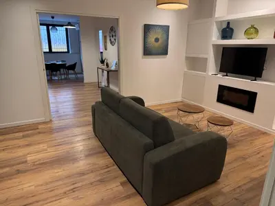 a living room with a couch and a television at Luce suite trastevere in Rome