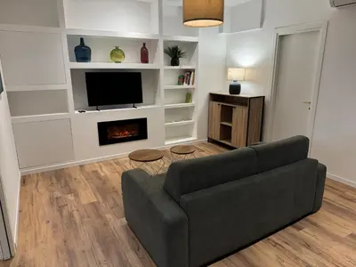 a living room with a couch and a fireplace at Luce suite trastevere in Rome