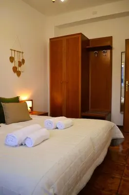 a bedroom with a large white bed with towels on it at Attico Aurelia Antica in Rome