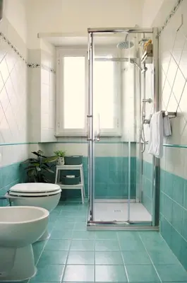 a bathroom with a shower and a toilet and a sink at Attico Aurelia Antica in Rome