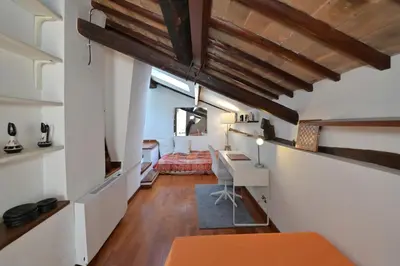 a room with a desk and a bed in a room at Domus Greci Piazza di Spagna in Rome