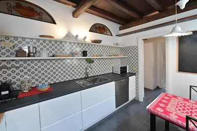 a kitchen with a sink and a counter top at Domus Greci Piazza di Spagna in Rome