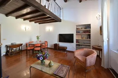 a living room with a table and a tv at Domus Greci Piazza di Spagna in Rome