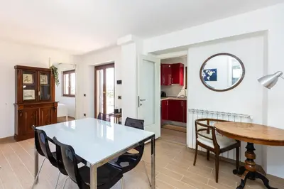 a kitchen and dining room with a table and chairs at San Pancrazio Penthouse by Rental in Rome in Rome