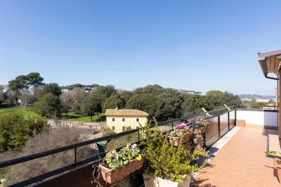 a balcony with potted plants on a building at San Pancrazio Penthouse by Rental in Rome in Rome