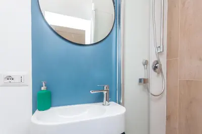 a bathroom with a mirror and a sink at Rhome Vatican Chic in Rome
