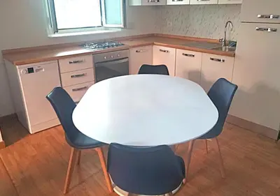 a kitchen with a white table and four chairs at Casita in Rome