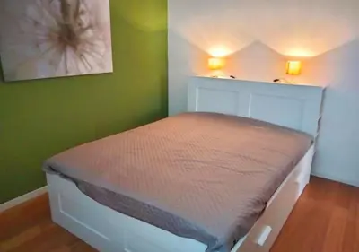 a bed in a room with a green wall at Casita in Rome