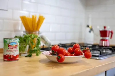 a bowl of tomatoes sitting on a kitchen counter at Roma Big terrace Home in Rome