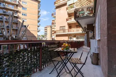 a table with a bowl of fruit on a balcony at Roma Big terrace Home in Rome