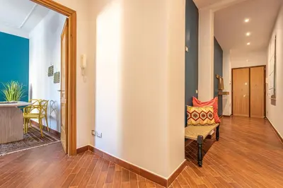 a hallway with a bench with a colorful pillow on it at YCH-Unique apartment near Vatican in Rome