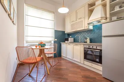 a kitchen with a table and chairs in a room at YCH-Unique apartment near Vatican in Rome