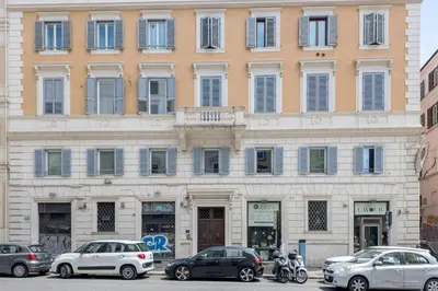 a large building with cars parked in front of it at The Best Rent - Spacious multi-room apartment on Via Cavour in Rome