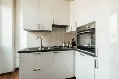 a white kitchen with white cabinets and a sink at The Best Rent - Spacious multi-room apartment on Via Cavour in Rome