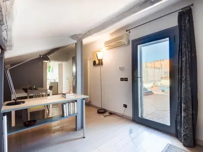 a room with a desk and a sliding glass door at Central Rome Terrace Apartment in Rome
