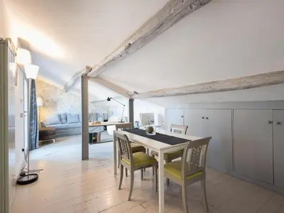 a kitchen and dining room with a table and chairs at Central Rome Terrace Apartment in Rome